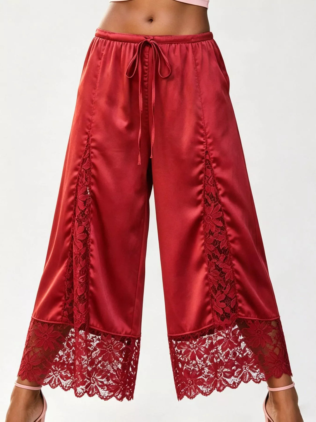 Red cropped wide leg pants with gathered drawstring waist and lace trim, front view