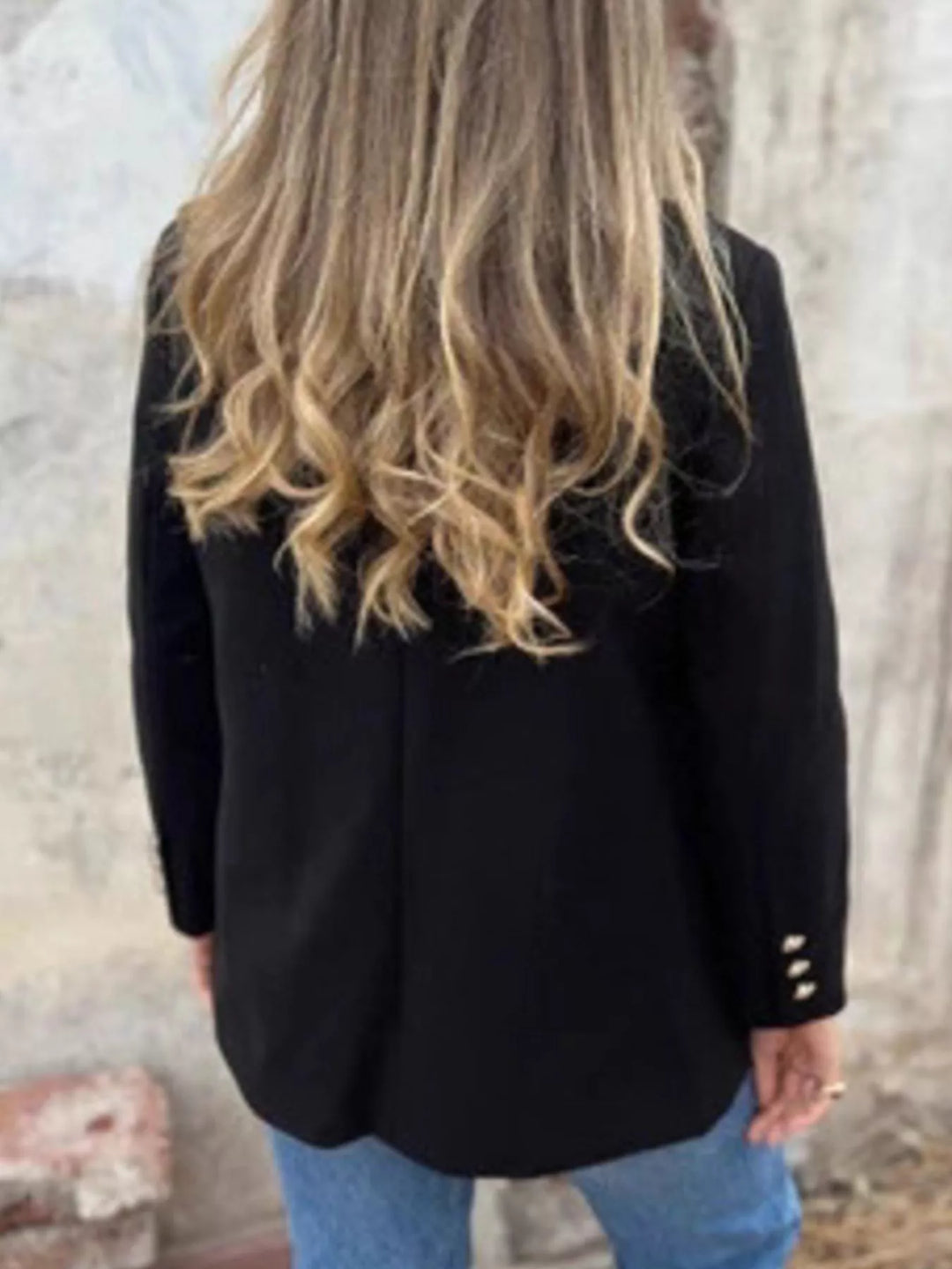 Back view of the black relaxed blazer with hip length cut