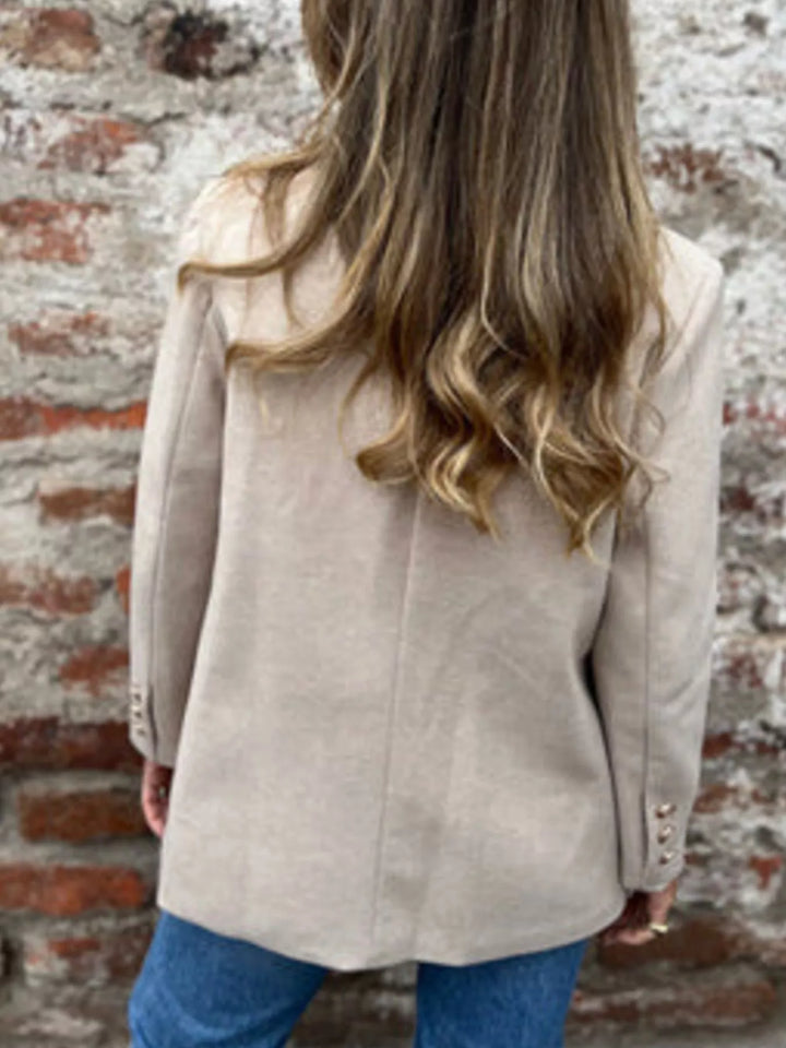 Back view of the oatmeal double breasted blazer with long wavy hair