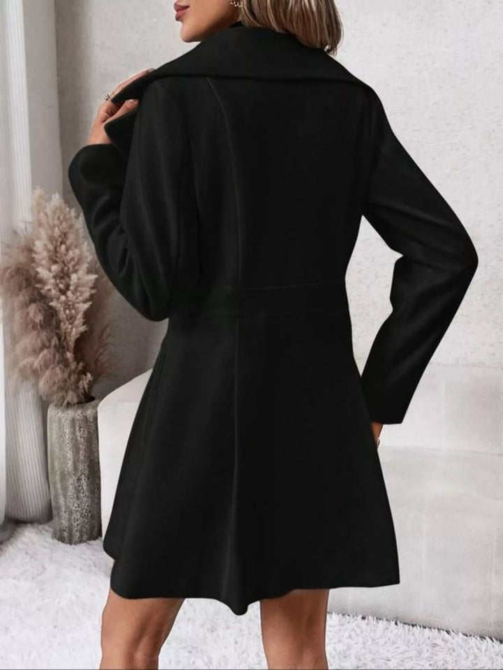 Back view of the black double breasted coat with hand at the collar