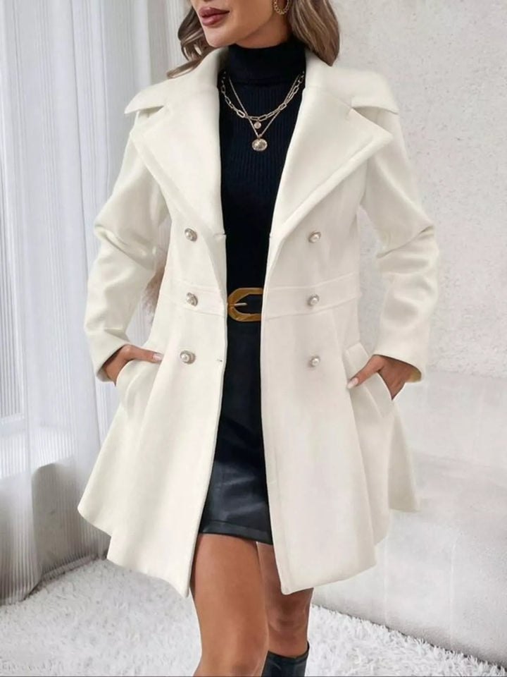 Women's double breasted coat in ivory, fitted waist with peplum skirt, front view