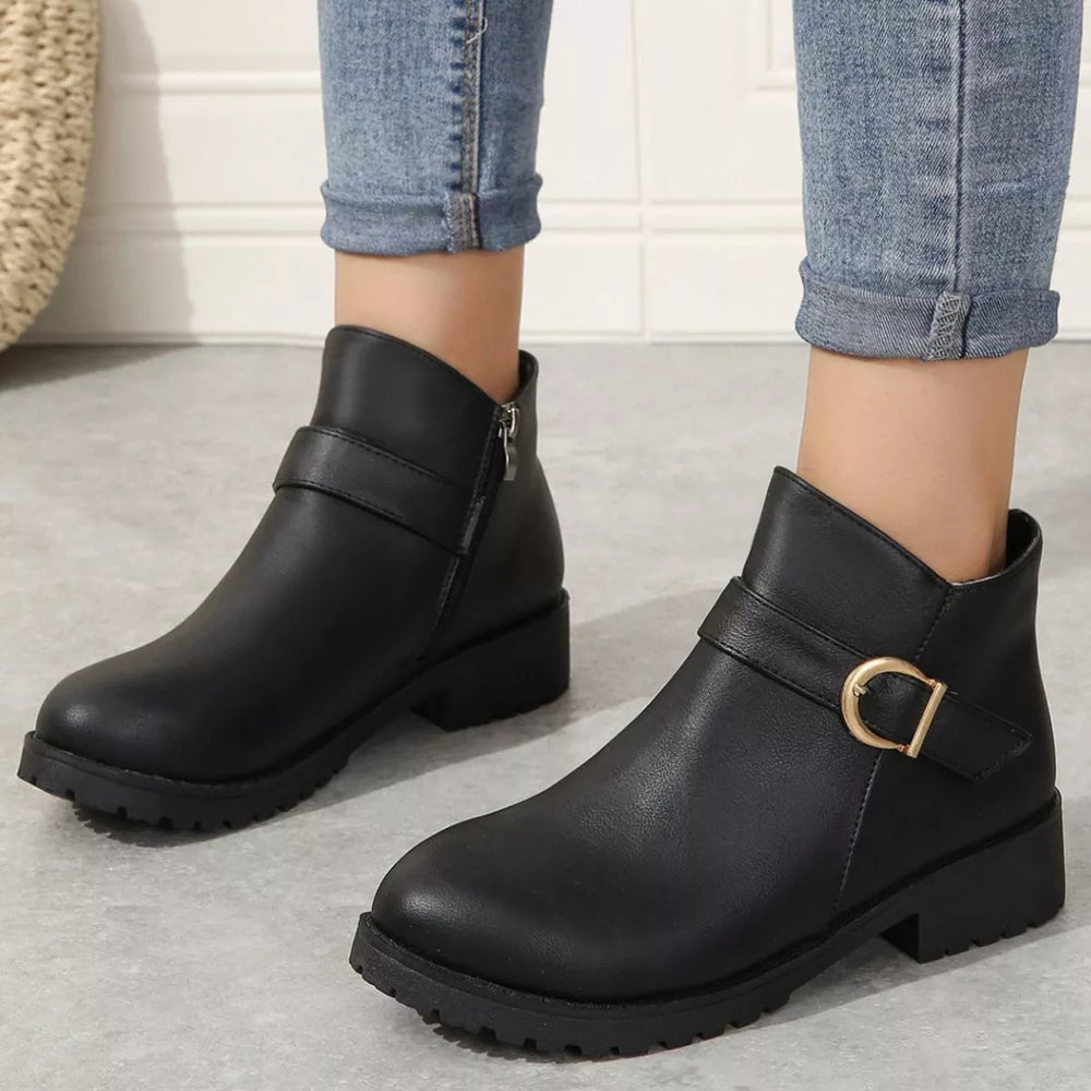 Black buckle ankle boots with low block heel, front view styled with cuffed jeans