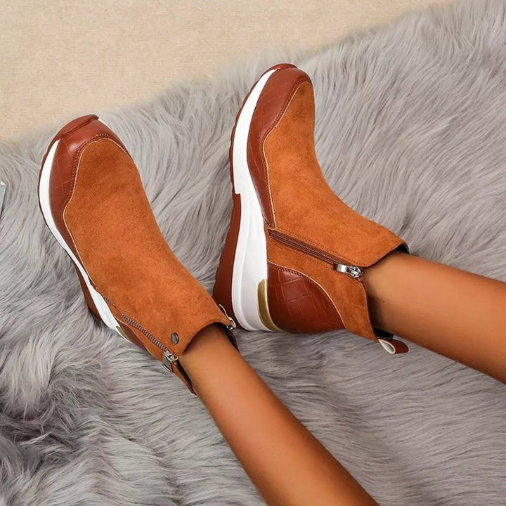 Cognac chunky wedge ankle boots seen from the side on a fur rug