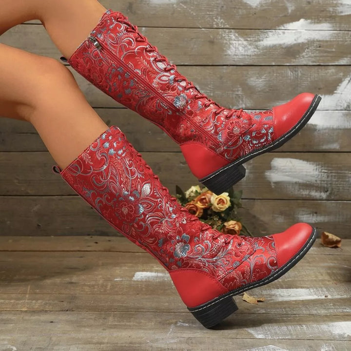 Red embroidered fall boots from the side showing a stacked heel and round toe
