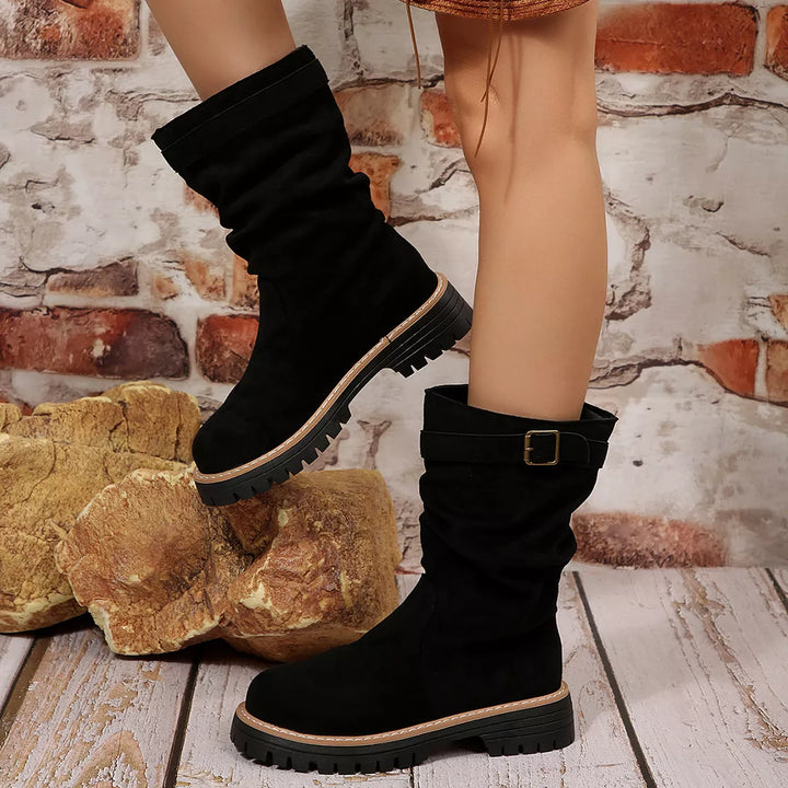 Side view of black slouch fall boots with chunky sole