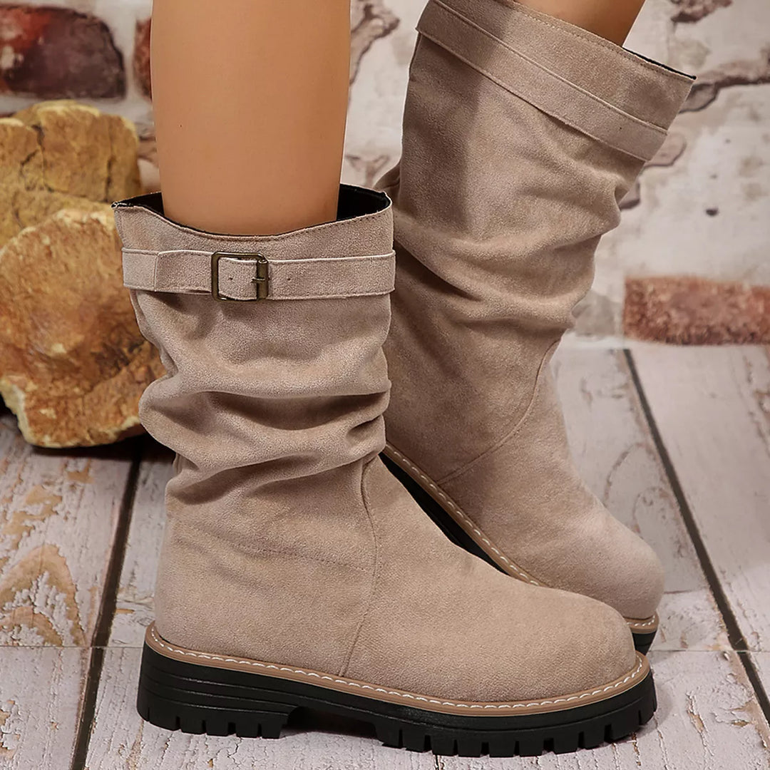 Pair of taupe slouch fall boots with buckle detail, front view