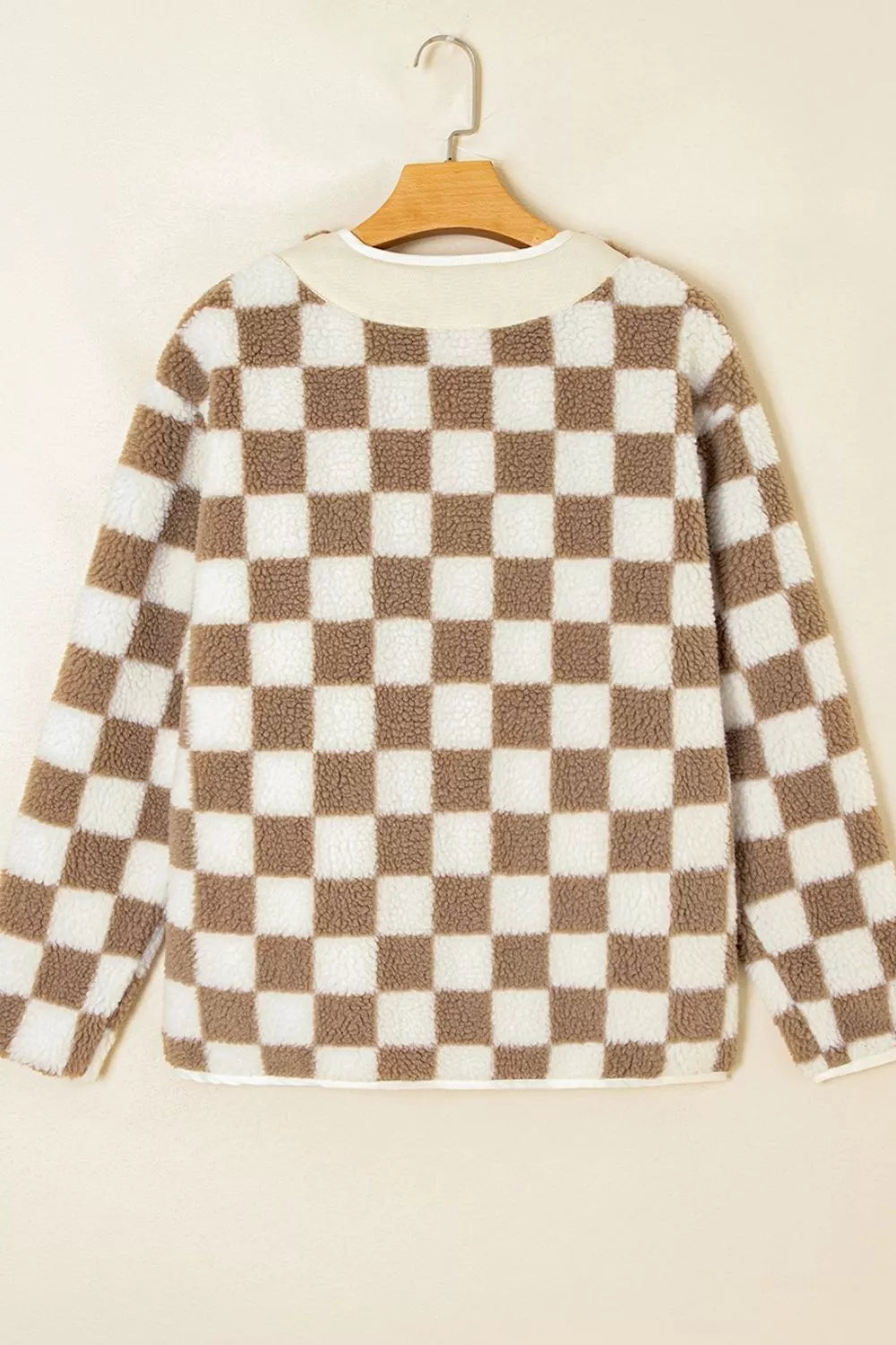Hanging view of the checkerboard plush jacket from the back