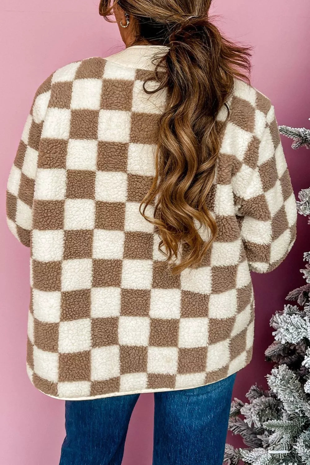 Back view of the brown checkerboard plush jacket with a high ponytail