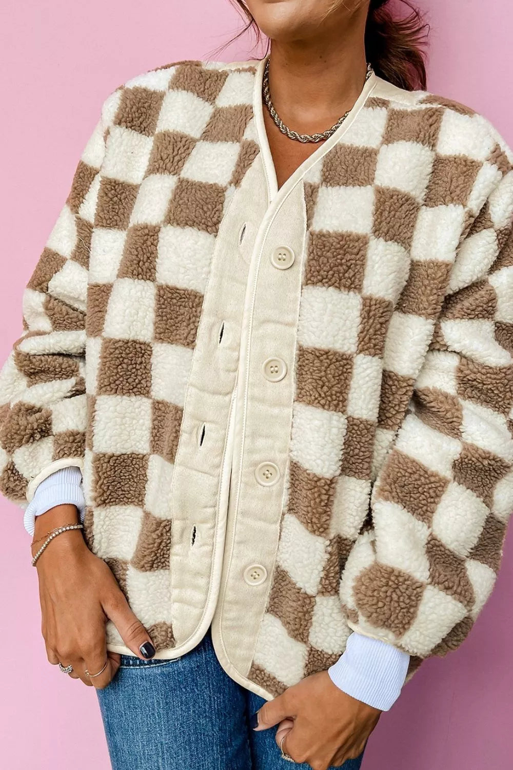 Brown checkerboard fall jacket buttoned up with pockets, front view