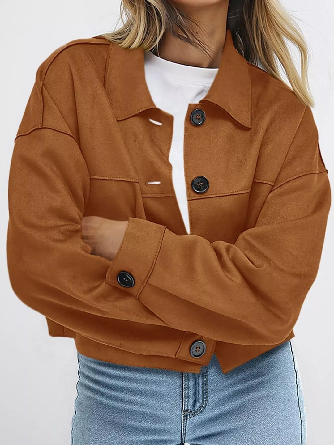 Caramel cropped jacket with arms crossed, worn over a white tee