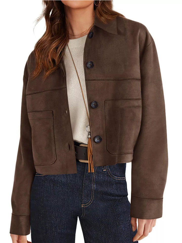 Coffee brown cropped jacket worn with dark jeans, angled view