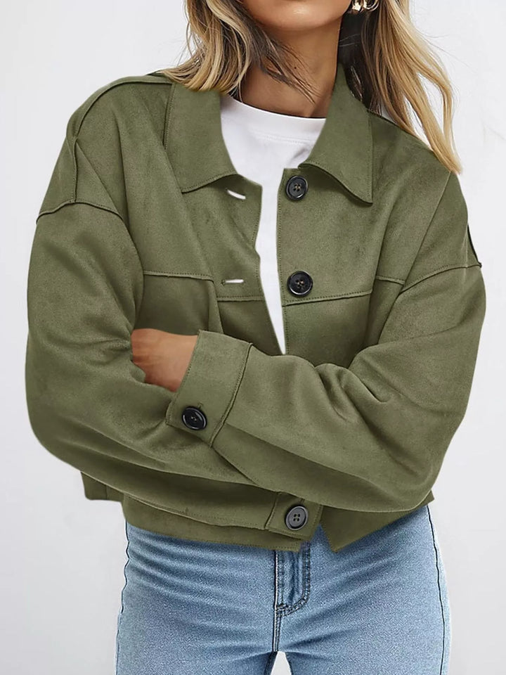 Olive green jacket with chest pockets, arms crossed pose
