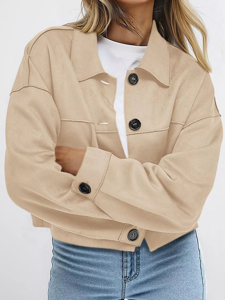 Sand cropped fall jacket with button front, arms crossed