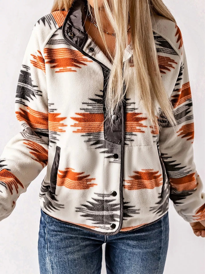 Gray Aztec print pullover jacket with front pocket and snap hem, angled view