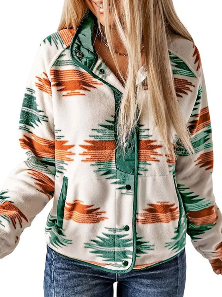 Green Aztec print fall jacket worn with a hand in pocket, side angle
