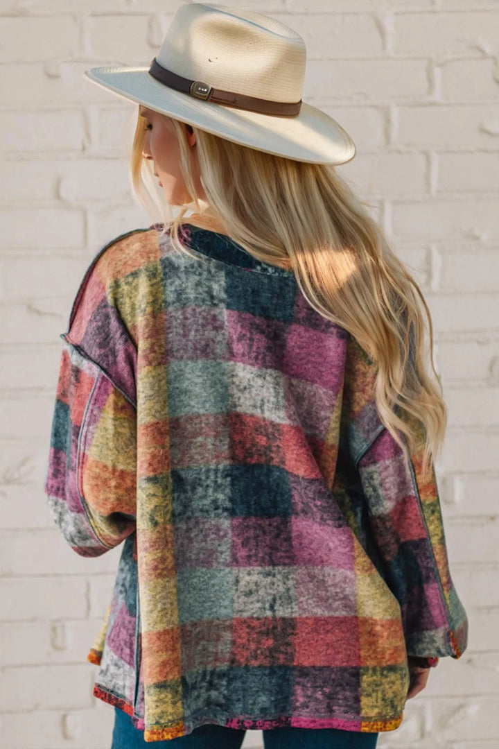 Back view of the multicolor patchwork plaid shacket worn with a straw hat