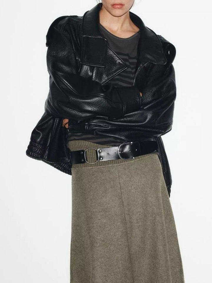 Black oversized moto jacket worn over a tee with a long skirt