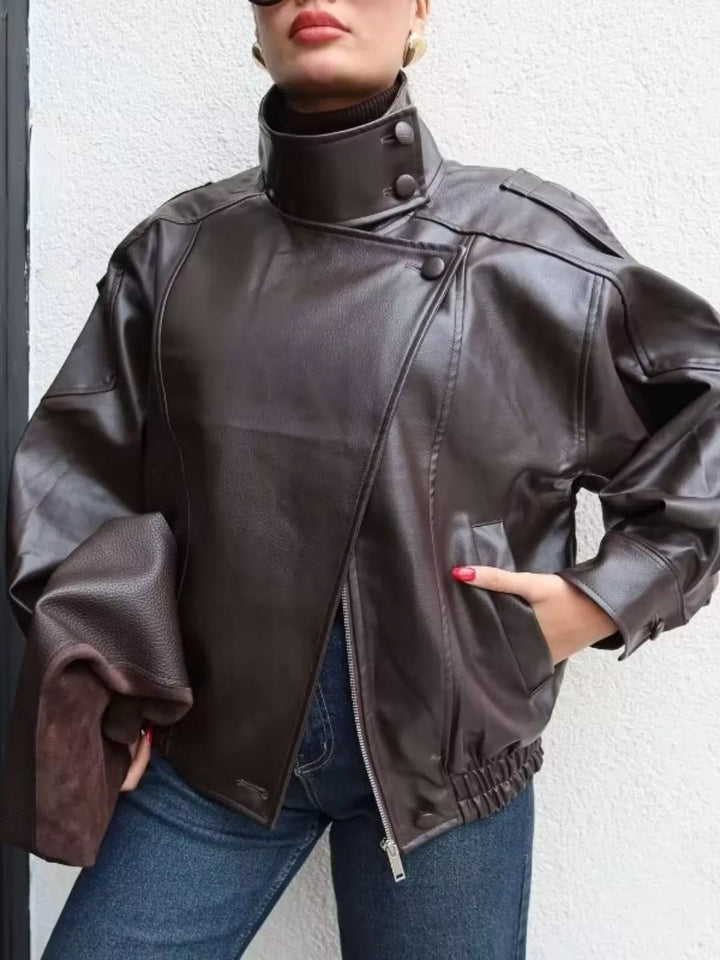 Chocolate funnel collar moto jacket with hand in pocket and jeans