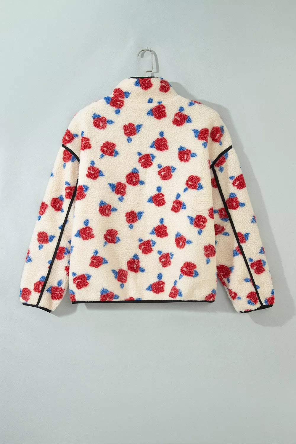Back view of the cream floral rose print jacket on a hanger