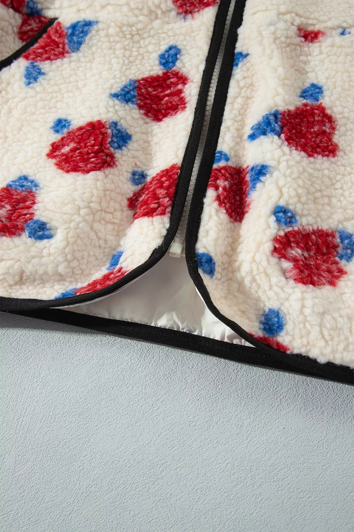Close-up of the zip placket and black trim on the floral plush jacket