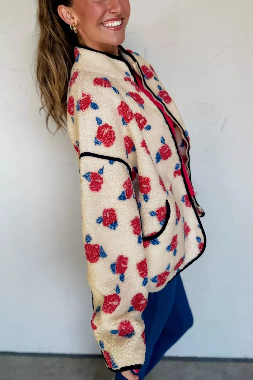 Cream floral plush jacket in angled side view with hair swept back