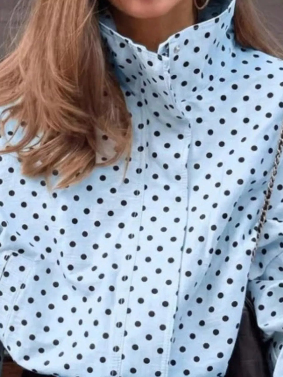 Polka dot zip front stand collar cropped in blue, close-up detail