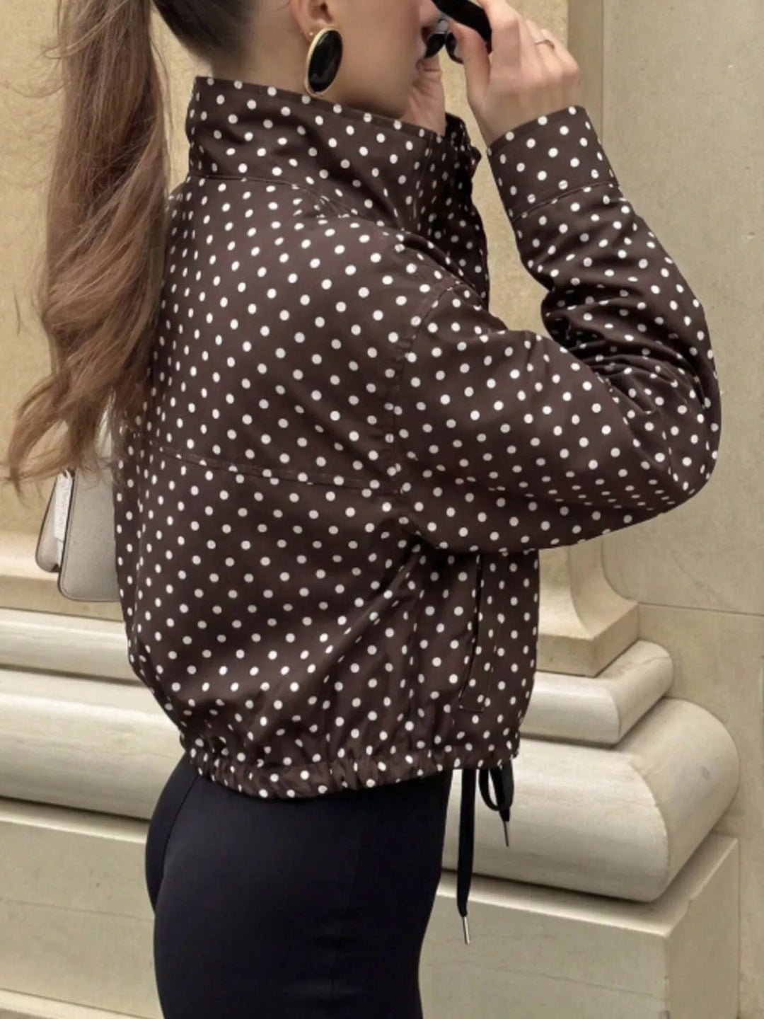 Polka dot zip front stand collar cropped in brown, styled on model