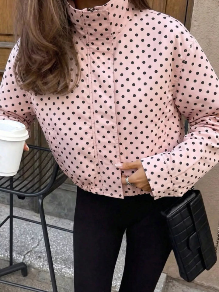 Polka dot zip front stand collar cropped in pink, close-up detail