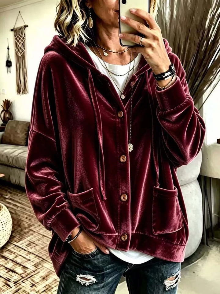 Burgundy velvet-look hooded button front jacket worn with jeans