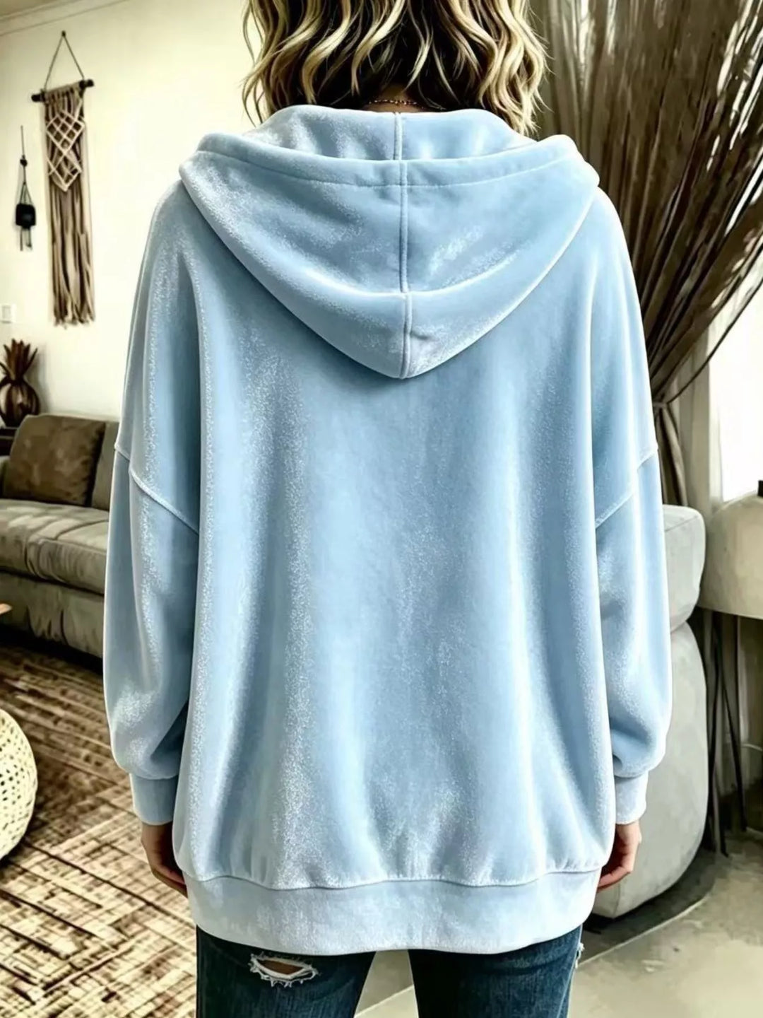 Back view of the light blue hooded jacket with a drop shoulder
