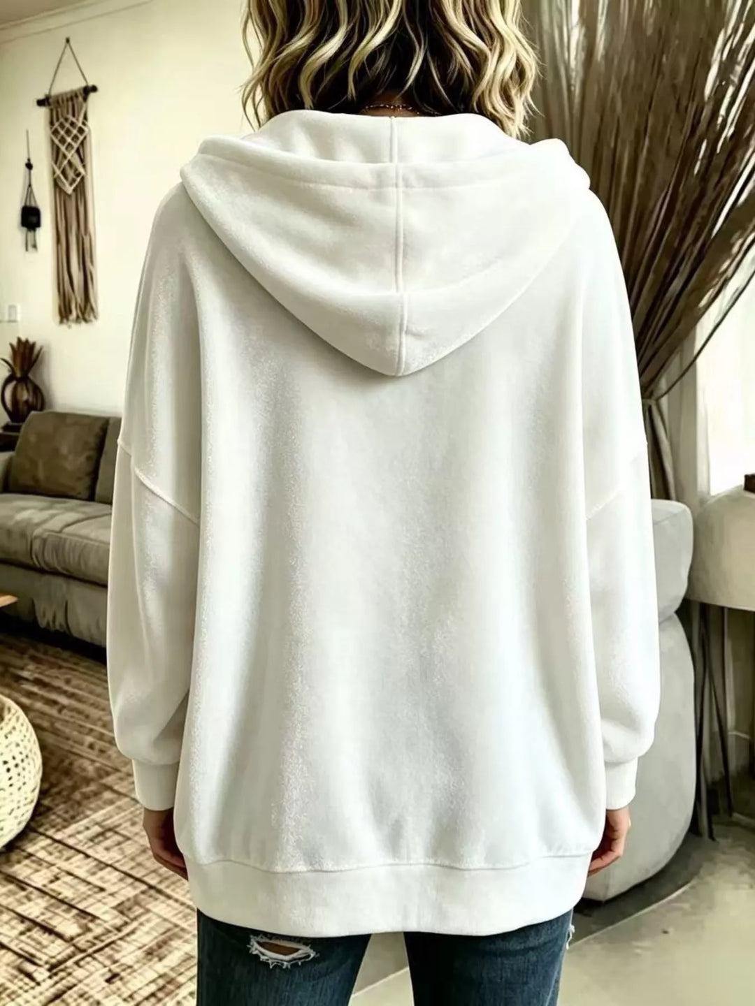 Back view of the white hooded jacket showing the relaxed hood