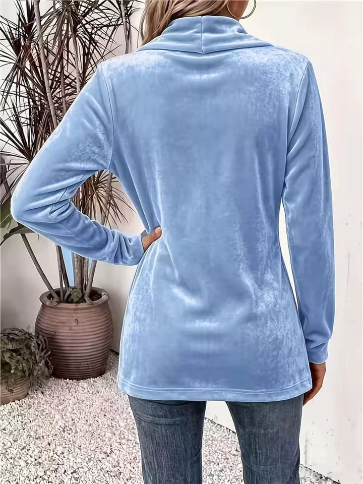 Back view of the sky blue open front jacket with a hand on the hip