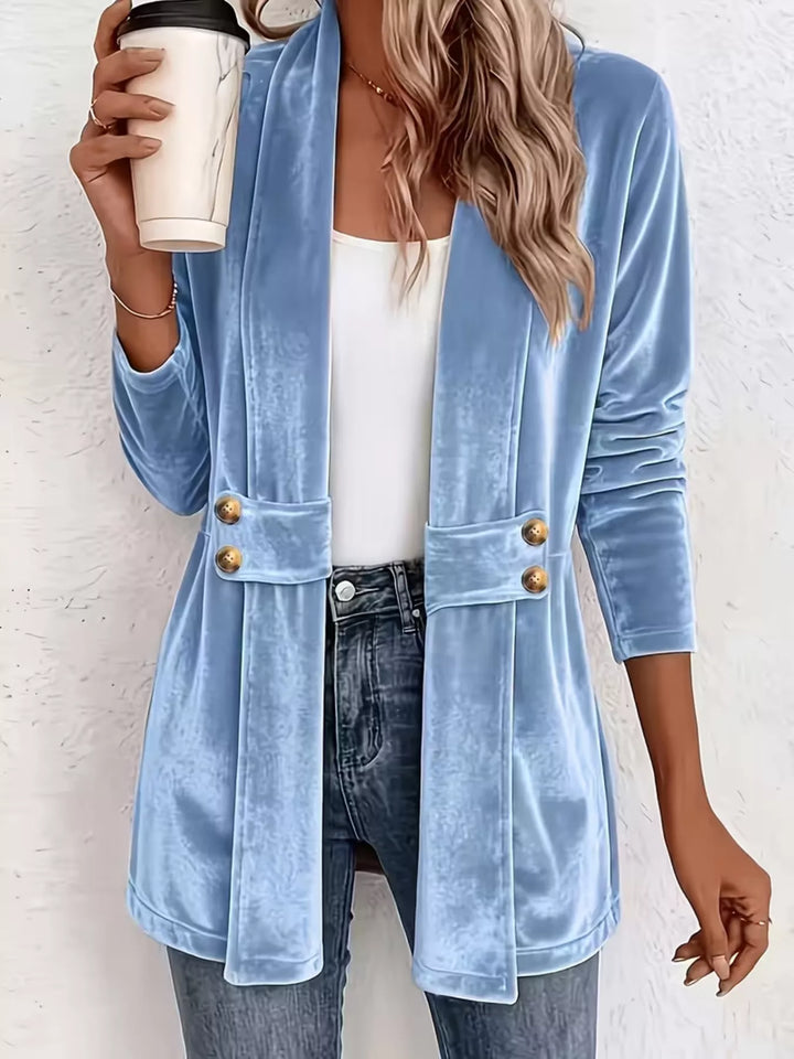 Women's fall jacket in sky blue, velvet-look open front with shawl collar, holding a coffee