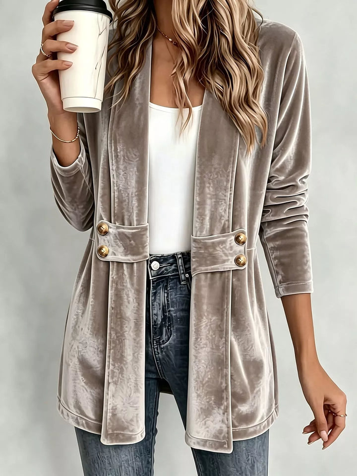 Taupe open front fall jacket with button waist detail, worn with jeans