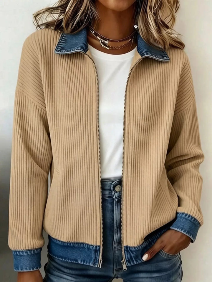 Tan zip front knit jacket with denim collar styled over a white tee and jeans
