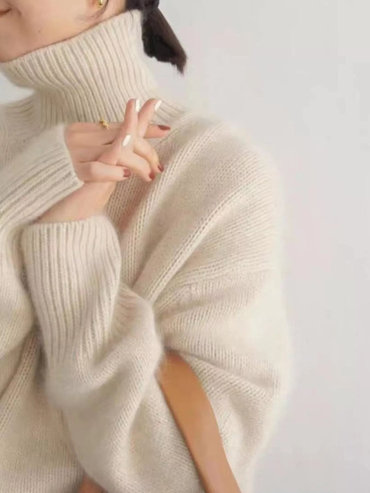Close-up of the cream sweater ribbed cuff and soft turtleneck