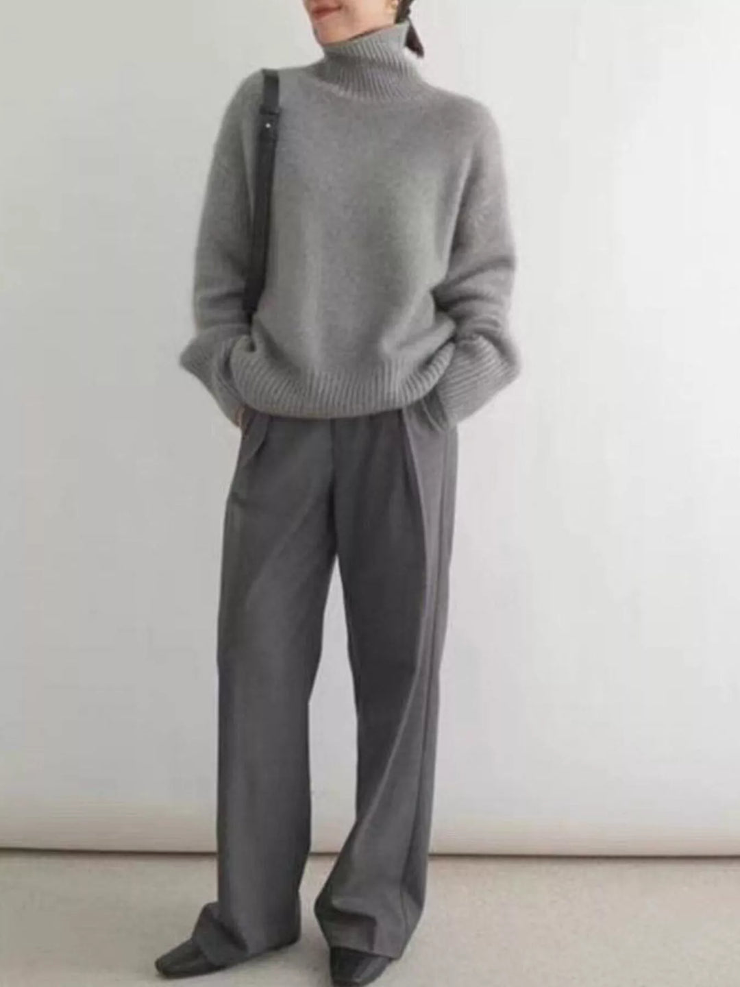 Full length look with gray turtleneck sweater and wide leg charcoal trousers
