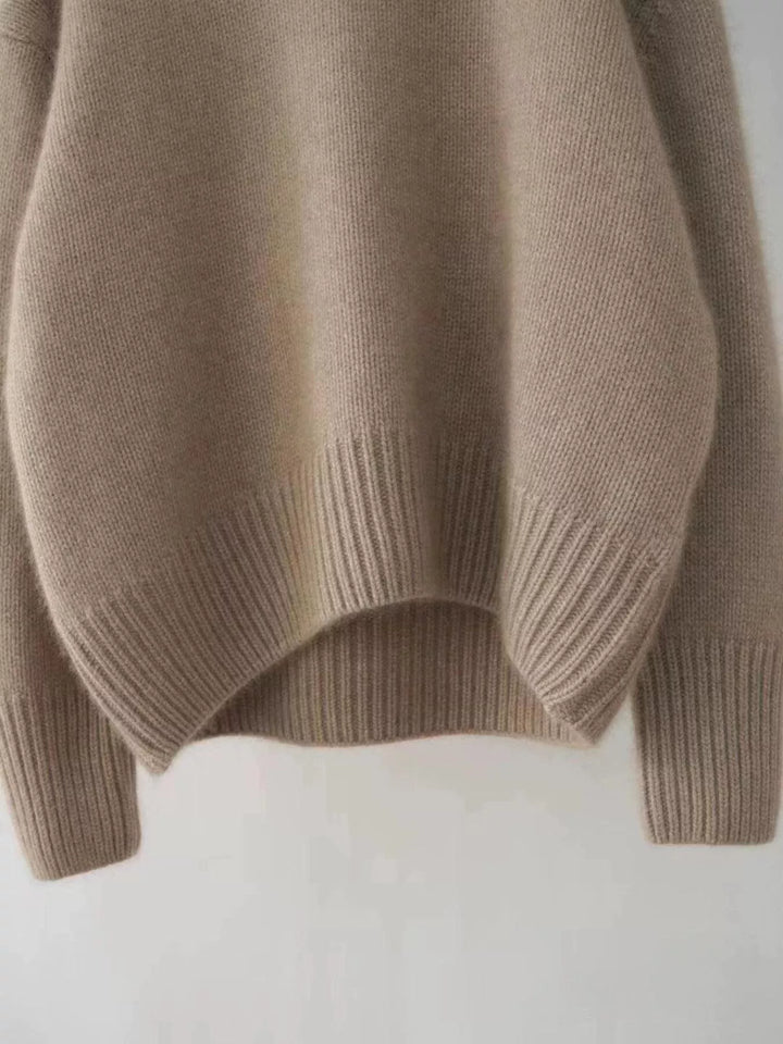 Mocha sweater ribbed hem and sleeve, close-up on a flat surface