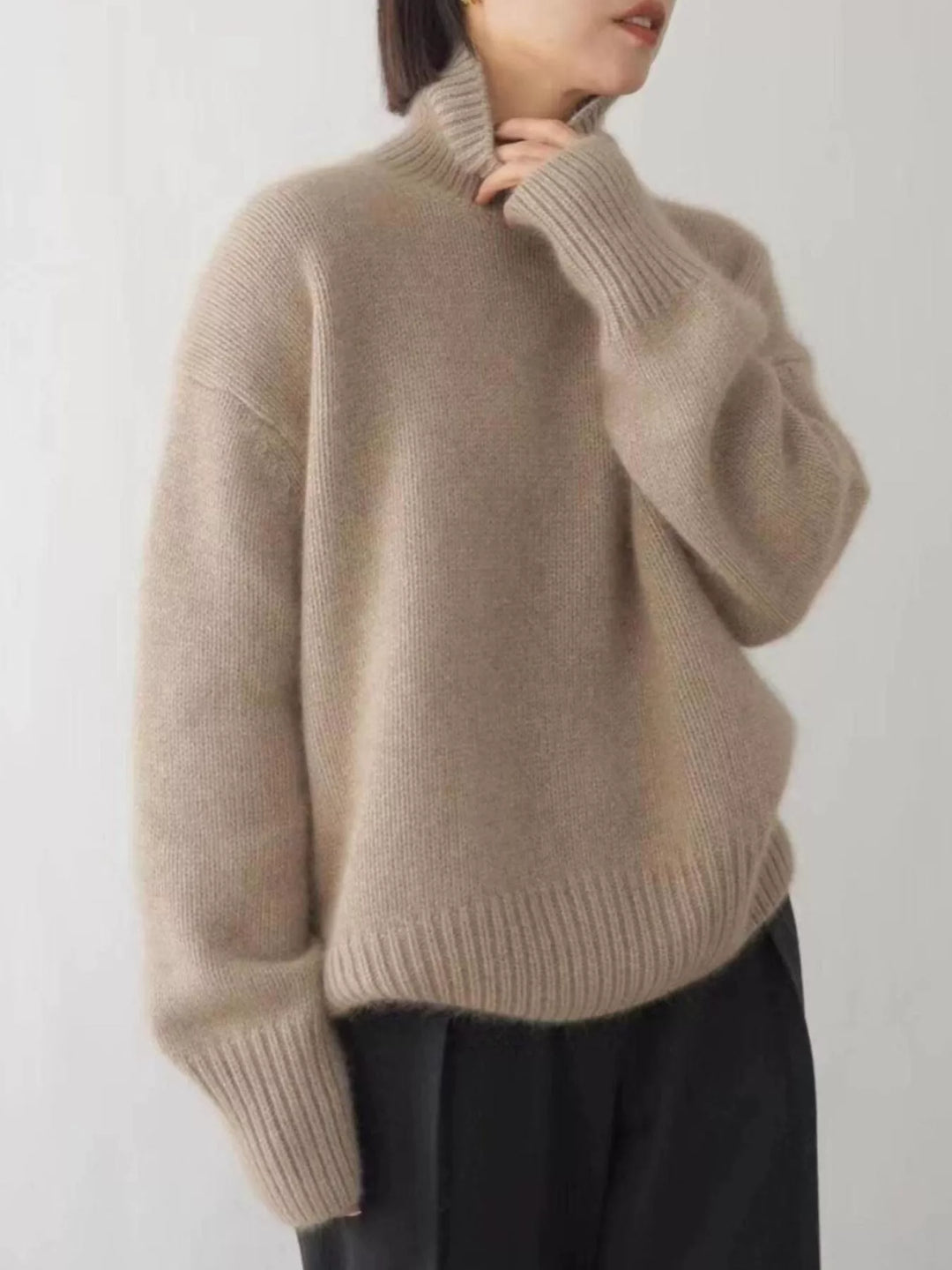 Sand fall sweater with dropped shoulders worn with black pants