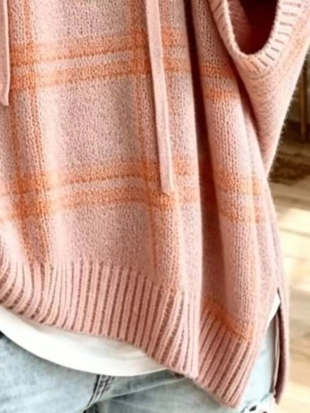 Close-up of the blush pink plaid knit with ribbed hem