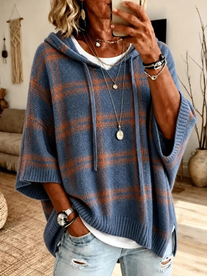 Women's slate blue plaid hooded sweater with batwing sleeves, worn with jeans