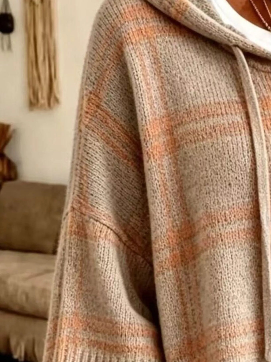Close-up of the taupe plaid knit sleeve and hood drawstring