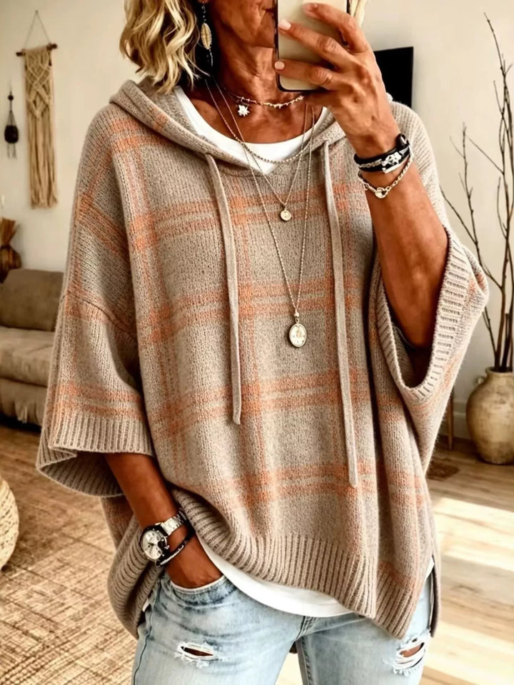 Taupe plaid hooded pullover with batwing sleeves, worn with light wash jeans