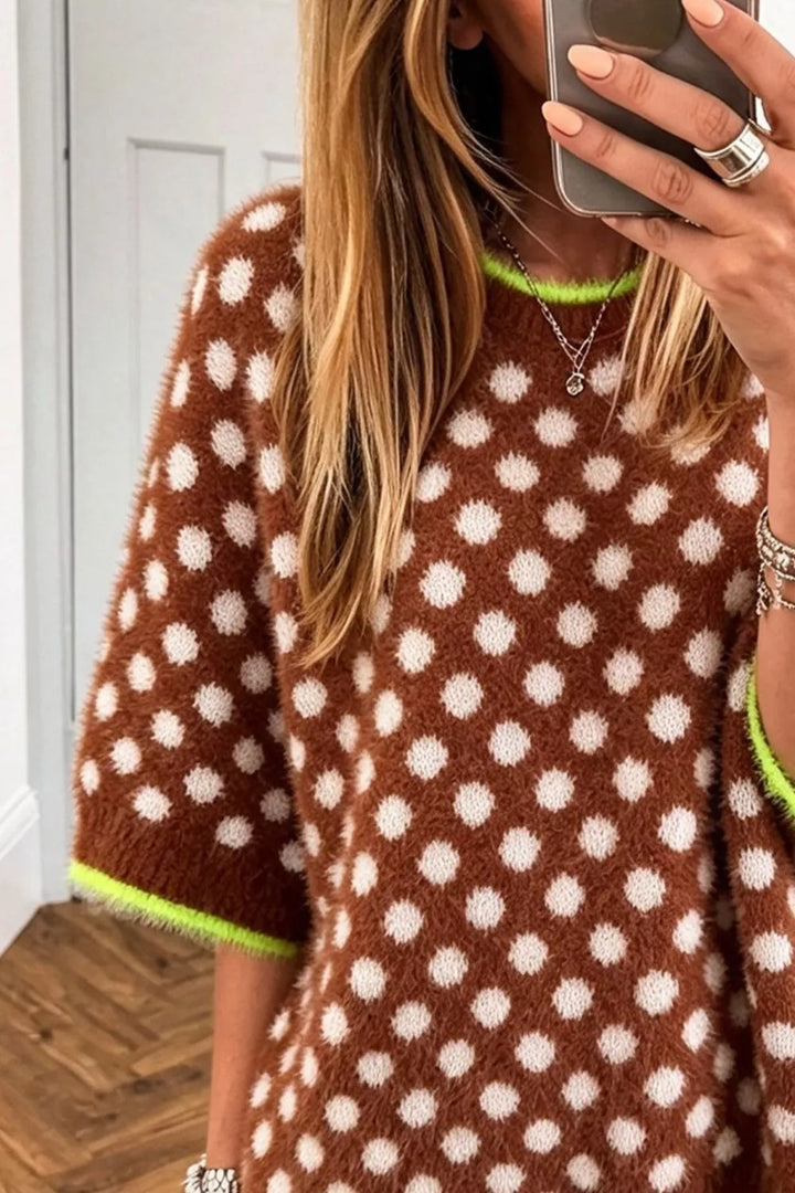 Close-up of the brown polka dot sweater with neon green trim at the neckline