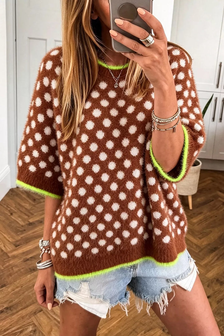 Women's brown fall sweater with polka dots and round neck, styled with denim shorts