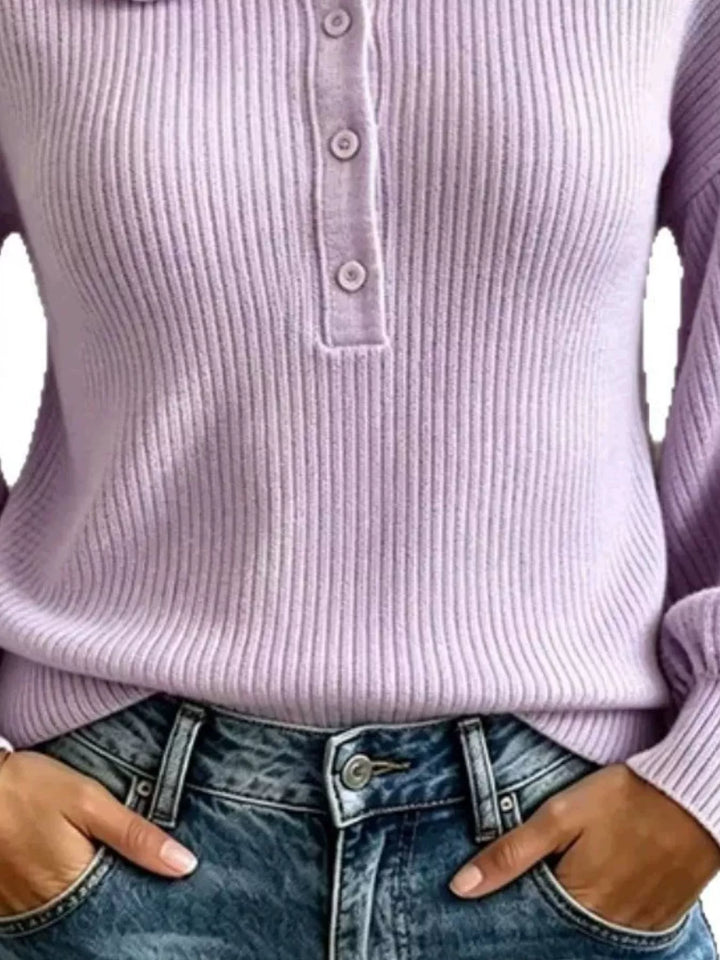 Detail of lavender ribbed knit sweater placket and hands in jeans pockets