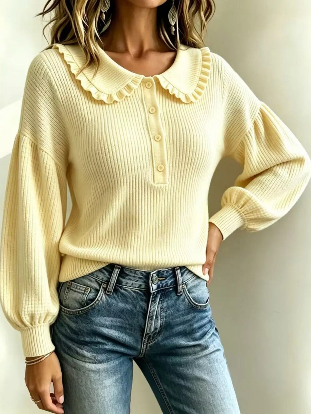 Light yellow sweater with ruffle Peter Pan collar, hand on hip