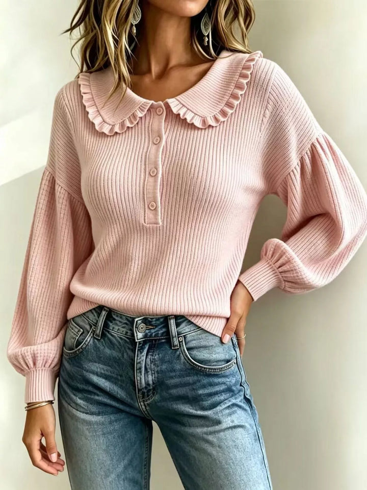 Pink fall sweater with puff sleeves and hand on hip, three quarter view