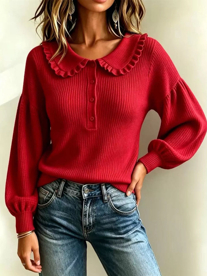 Red fall sweater styled with jeans and hand on hip