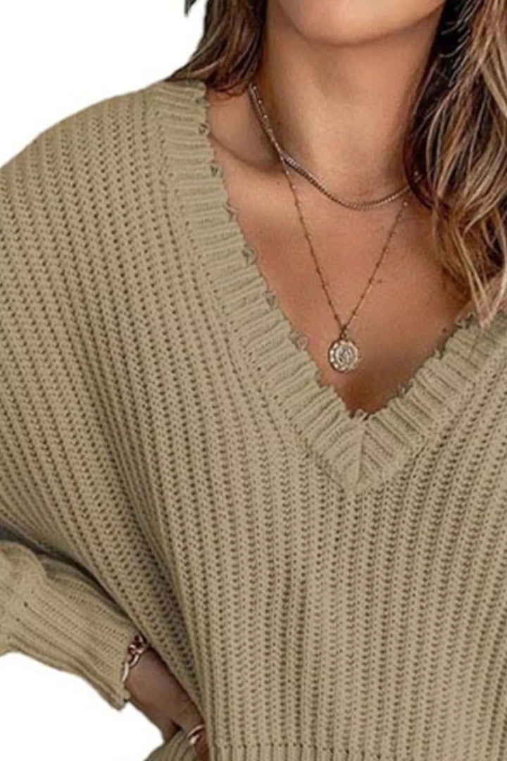 Close-up of the khaki sweater deep v-neckline and ribbed knit